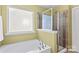 Bathroom with shower and tub, and a window at 140 Falls Cove Dr, Troutman, NC 28166