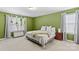 Spacious bedroom with king-size bed and green walls at 140 Falls Cove Dr, Troutman, NC 28166