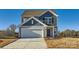 Two-story home with gray siding, white garage door, and landscaping at 158 Smokey Way, Statesville, NC 28625