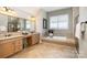 Bathroom boasts double vanity, soaking tub, and walk-in shower at 3014 Highbury Pl, Weddington, NC 28104