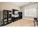 Versatile bonus room with built-in shelving, large TV, and comfortable seating at 3014 Highbury Pl, Weddington, NC 28104