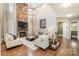 Open living room with hardwood floors and a stone fireplace at 3014 Highbury Pl, Weddington, NC 28104