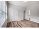 Well-lit bedroom featuring wood-look floors and double doors at 3702 Small Ave, Charlotte, NC 28269