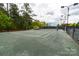 Full-size tennis court with a fence and lighting at 4022 Blackburn Ct, Fort Mill, SC 29707