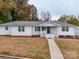 Ranch-style home with a front yard, walkway and attached garage at 504 N Pine Ln, Wadesboro, NC 28170