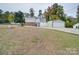 Rear view of house with detached garage and yard at 504 N Pine Ln, Wadesboro, NC 28170