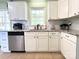 Modern kitchen with white cabinets, granite countertops, and stainless steel appliances at 507 Texas Trl, Dallas, NC 28034