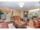 Living room with leather furniture, hardwood floors, and access to dining area at 7546 Lady Liberty Ln, Charlotte, NC 28217