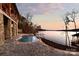 Kidney-shaped pool with lake views and spacious patio at 8058 Edgewater Dr, Norwood, NC 28128