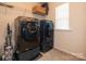 Laundry room with washer, dryer, and shelving at 110 Champion Ct, Mooresville, NC 28117