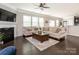 Bright living room featuring hardwood floors and a fireplace at 110 Champion Ct, Mooresville, NC 28117