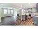 Open kitchen with island, stainless steel appliances, and gray cabinets at 14854 Tamarack Dr, Charlotte, NC 28278