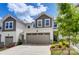 Townhome exterior featuring a taupe garage door and landscaping at 14858 Tamarack Dr, Charlotte, NC 28278