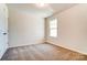 Bright bedroom featuring neutral walls and carpeted floors at 14862 Tamarack Dr, Charlotte, NC 28278