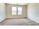 Bright bedroom with neutral carpeting and large windows at 14862 Tamarack Dr, Charlotte, NC 28278