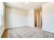 Simple bedroom with carpet, large window and closet at 14862 Tamarack Dr, Charlotte, NC 28278