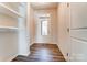 Bright foyer with hardwood floors, built-in shelves, and coat hooks at 14862 Tamarack Dr, Charlotte, NC 28278