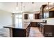 Modern kitchen with granite countertops, dark cabinetry, and stainless steel appliances at 14862 Tamarack Dr, Charlotte, NC 28278