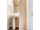 Small powder room with pedestal sink and octagon mirror at 14862 Tamarack Dr, Charlotte, NC 28278