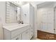 White bathroom vanity with a large mirror and a walk-in shower at 2675 Faith Rd, Salisbury, NC 28146