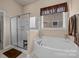 Spa-like bathroom featuring a soaking tub and a separate shower at 3006 Cricket Ln, Lancaster, SC 29720