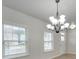 Dining room with hardwood floors, chandelier, and two windows at 5065 Thomasville Dr, Belmont, NC 28012