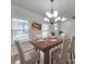 Dining room with wood table, chandelier, and neutral decor at 5065 Thomasville Dr, Belmont, NC 28012