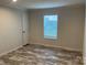 Simple bedroom with wood-look flooring and window with blinds at 51 Rosemont Dr, Stony Point, NC 28678