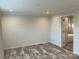 Spacious bedroom with wood-look flooring and access to bathroom at 51 Rosemont Dr, Stony Point, NC 28678