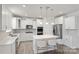 Modern kitchen with white cabinets, stainless steel appliances, and an island at 6416 Willow Pin Ln, Huntersville, NC 28078