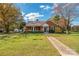 Brick home with a porch, walkway, and well-maintained lawn at 103 2Nd Nw St, Catawba, NC 28609