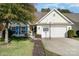 House exterior showcasing a two-car garage and well-kept lawn at 11638 Village Pond Dr, Charlotte, NC 28278