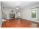 Living room with hardwood floors, fireplace, and access to the kitchen at 12077 Marsh Hen Ln, Tega Cay, SC 29708