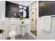 Modern bathroom with black and white tile and pedestal sink at 1820 Townsend Ave, Charlotte, NC 28205