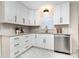 Modern kitchen with white cabinets, stainless steel appliances, and patterned tile floor at 1820 Townsend Ave, Charlotte, NC 28205