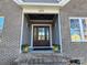 Dark stained front door with glass panes and sidelights at 405 19Th Ave Nw Cir, Hickory, NC 28601