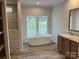 Main bathroom with soaking tub and walk-in shower at 568 Drumstand Rd, Stony Point, NC 28678