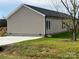 Tan single story home with gray trim, deck, and spacious yard at 568 Drumstand Rd, Stony Point, NC 28678