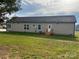 Rear view of house with grassy backyard at 568 Drumstand Rd, Stony Point, NC 28678