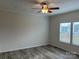Bright living room with ceiling fan and large windows at 568 Drumstand Rd, Stony Point, NC 28678