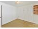 Simple bedroom with light wood floors and built-in storage at 716 Ellsworth Rd, Charlotte, NC 28211