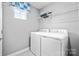 Convenient laundry room with washer, dryer, and overhead shelving at 7315 Childress Sw Dr, Concord, NC 28025