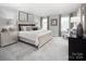 Spacious bedroom with a large bed, gray carpet, and two nightstands at 7329 Braswell Sw Dr, Concord, NC 28025