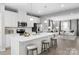 Open concept kitchen with island, white cabinets, and stainless steel appliances at 7329 Braswell Sw Dr, Concord, NC 28025