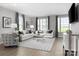 Living room with light gray sofas, patterned rug, and large windows at 7329 Braswell Sw Dr, Concord, NC 28025