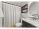 Clean bathroom with granite countertop, striped shower curtain, and shelving at 907 Southwest Dr, Davidson, NC 28036