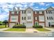 Brick front townhouse with two-car garage and landscaping at 140 Rock Ridge Ln, Mount Holly, NC 28120