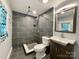 Modern bathroom with gray tile and updated vanity at 142 Swink Sw St, Concord, NC 28027