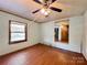 Bright bedroom featuring a large window and wood flooring at 142 Swink Sw St, Concord, NC 28027