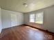 Well-lit bedroom with wood flooring and a door to hallway at 142 Swink Sw St, Concord, NC 28027